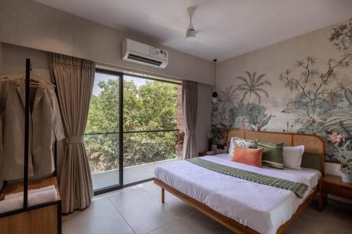 Un dormitorio con una cama y una ventana grande. en Soam Villa - Theatre Room, Plunge Pool & Jacuzzi, en Lonavala