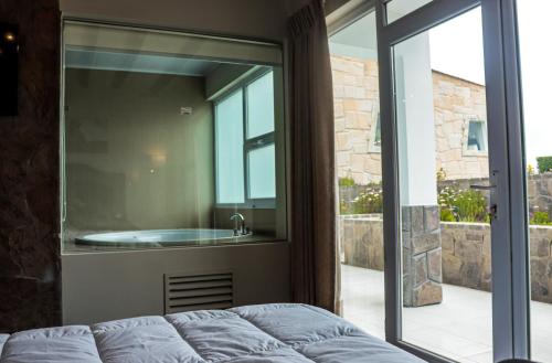 a master bathroom with a tub and a window at Hotel Puerta del Sol Colca in Yanque