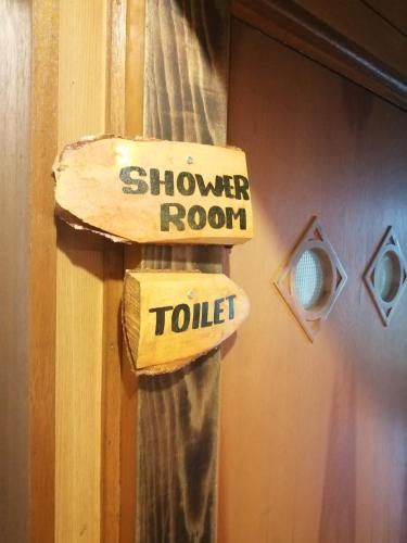 a door with a sign that says shower room toilet at Yukiumi House in Kamikawa
