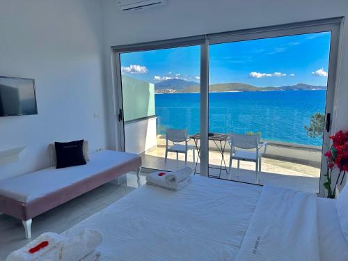 a living room with a view of the ocean at Sea Horizon Vsl Suites & Apartments in Sarandë