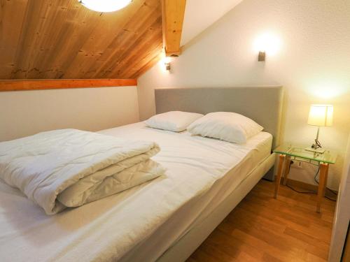 - un grand lit blanc avec 2 oreillers dans l'établissement Appartement Valfréjus, 3 pièces, 8 personnes - FR-1-468-68, à Valfréjus