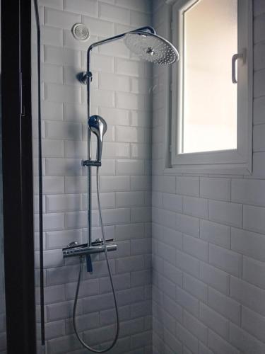 a shower with a shower head in a bathroom at Bois d'Yevre in Vierzon