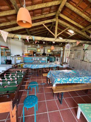 a room with tables and chairs and a pool table at Quinta Laranja - Turismo Rural - in Alvorninha