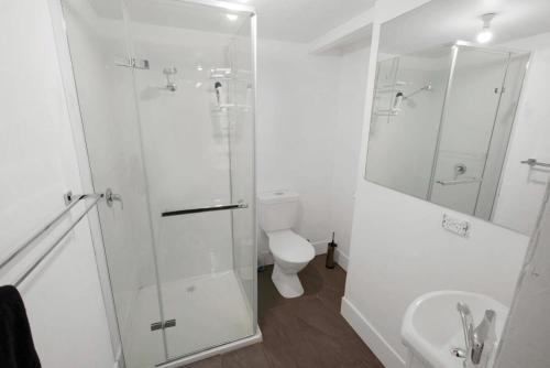 a bathroom with a shower and a toilet and a sink at Nautique in Metung