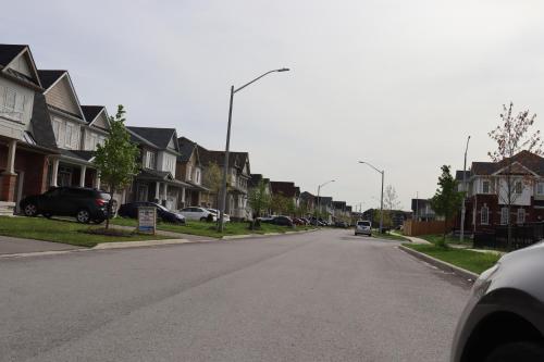 an empty street in a residential neighborhood with houses at Spacious stay, 15 min to Niagara Falls & US border in Thorold
