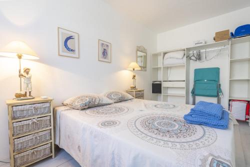 a bedroom with a bed and a chair at Belle maison bleu azur in Six-Fours-les-Plages