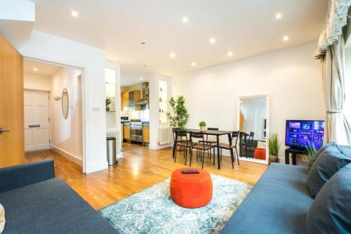 a living room with a couch and a table at Comfortable family villa in London