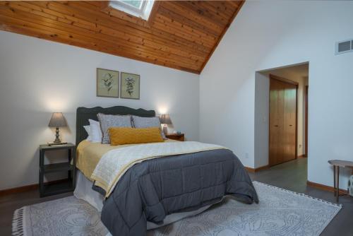 a bedroom with a bed and a wooden ceiling at Large home & Close to beach in South Haven