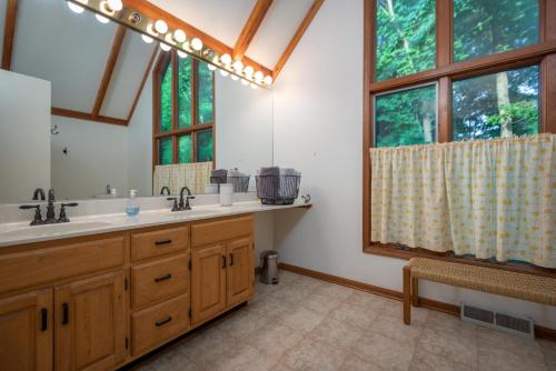 a bathroom with a sink and a large window at Large home & Close to beach in South Haven