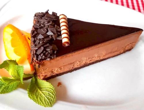 a piece of chocolate cake on a white plate at Blumenhof Bucovina in Voronet