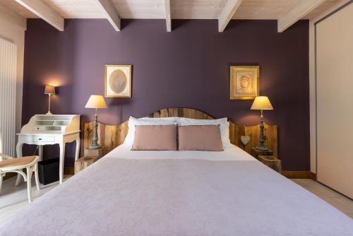 a bedroom with a large bed and a piano at Château La Gravière in Vertheuil-en-Médoc