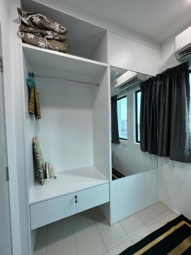 a room with white shelves in a train at Sirami homestay in Kampar