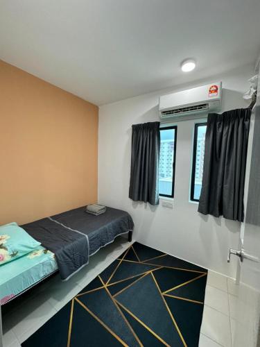 a small room with a bed and two windows at Sirami homestay in Kampar