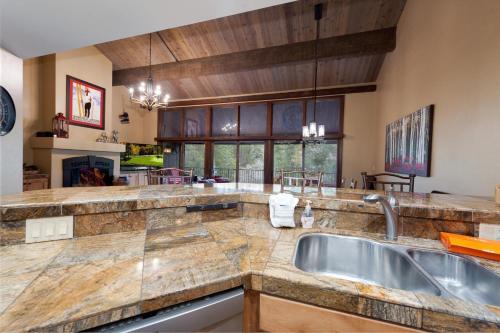 a large kitchen with a sink and a counter top at Tamarron PineCone 828 in Durango