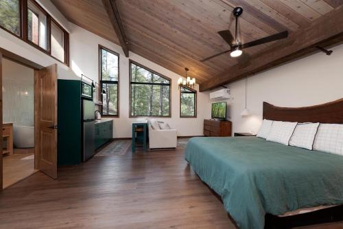 a bedroom with a green bed and a bathroom at Tamarron PineCone 828 in Durango