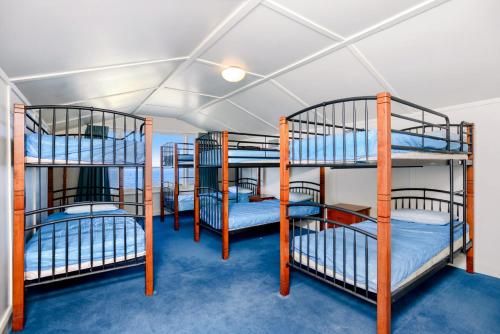 a group of bunk beds in a room at Beachfront Bliss - Wi-fi Bbq Group House in Victor Harbor