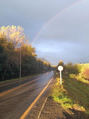 a road with a sign on the side of the road at Cabaña Beatriz in Coñaripe