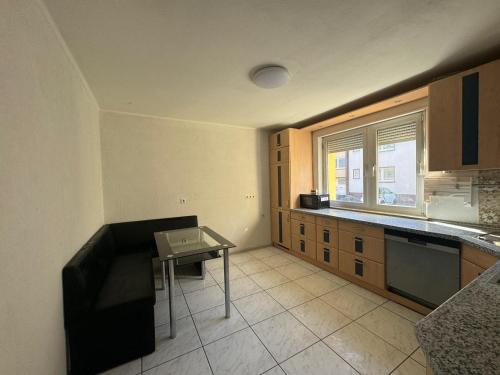 an empty kitchen with a table and a window at 7 Zimmer Haus in Kaiserslautern in Kaiserslautern