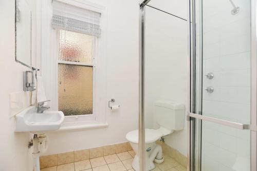 uma casa de banho com um WC, um lavatório e um chuveiro em Cecil Mansions Wi-fi Parking Central Location em Adelaide