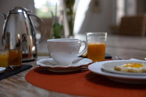 a table with a cup of coffee and a glass of orange juice at Château La Gravière in Vertheuil-en-Médoc