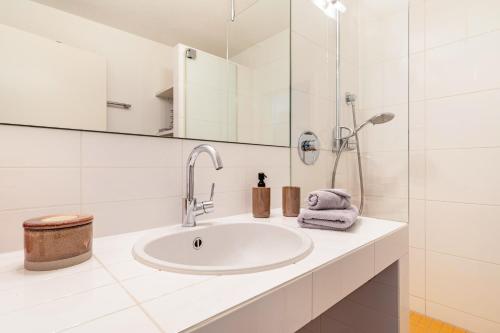 a white bathroom with a sink and a mirror at Great Stay in Boll in Bad Boll