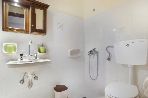 a bathroom with a toilet and a sink and a shower at Castellos Bellos Studio 3 in Marathias