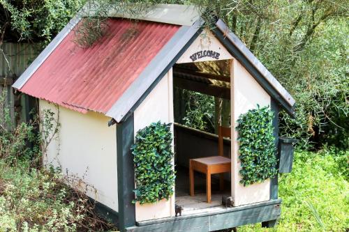 a small dog house with a red roof at Sandy Pool Shack - Pet Friendly in Seacliff