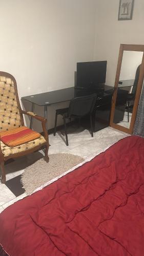 a bedroom with a desk and a chair and a table at Laila in Creil