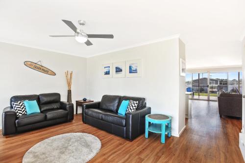a living room with two chairs and a couch at Sa Holiday House 'dunes Views On Simpson' in Goolwa