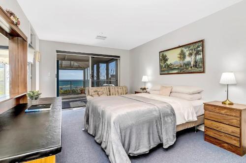 a bedroom with a bed and a view of the ocean at The Darling Of Marina - A Hilltop And Sea Getaway in Wirrina Cove