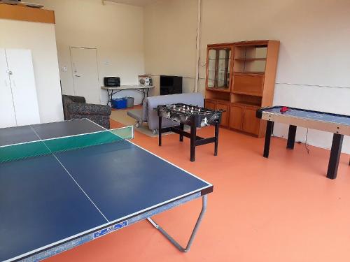 a room with two ping pong tables in it at The Darling Of Marina - A Hilltop And Sea Getaway in Wirrina Cove