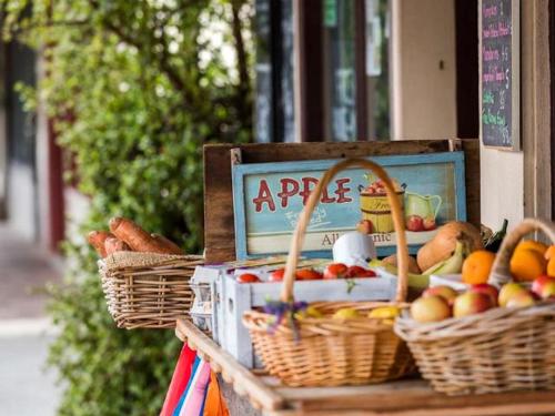 a display of baskets of fruit and vegetables on a table at Southern Sands' Beachfront Apartment in Port Elliot