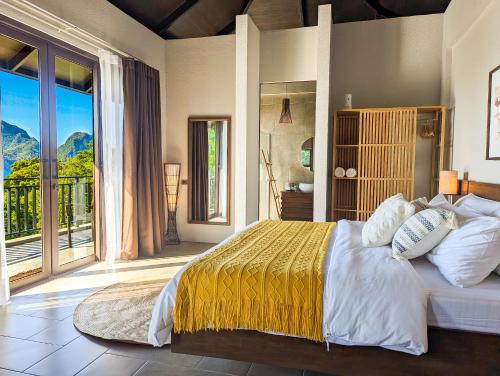 a bedroom with a large bed and a balcony at Perch El Nido's Seaview Villas Marimegmeg Beach in El Nido