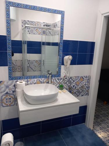 a bathroom with a sink and a mirror at La Dolce Vita in Naples