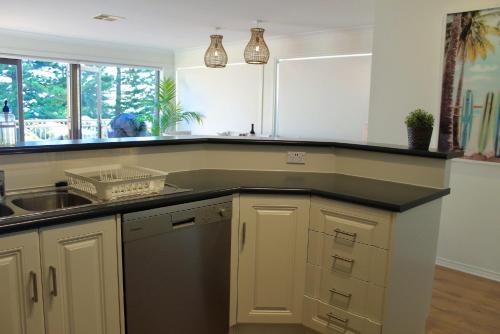 a kitchen with a sink and a counter top at Vista Victor Harbor Beachfront Apartment No 4 in Victor Harbor