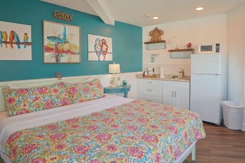 a bedroom with a bed and a white refrigerator at Inn at Camachee Harbor View 24 in Saint Augustine