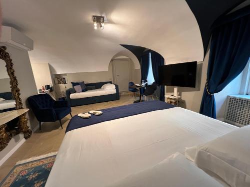 a bedroom with a bed and a living room at Rome luxury blue suites- IMPERIAL in Rome