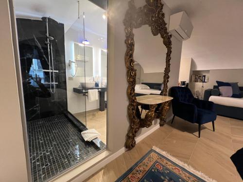 a living room with a mirror and a bedroom at Rome luxury blue suites- IMPERIAL in Rome