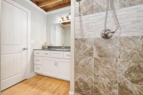 a bathroom with a shower and a sink at Central Lofts condo- year round pool- hot tub- close to beach in South Haven