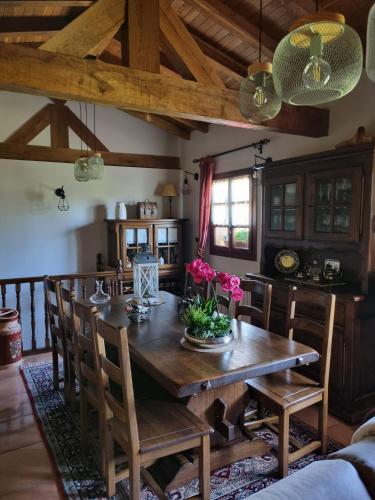 a dining room with a wooden table and chairs at Gaztañeta Baserria in Olaeta