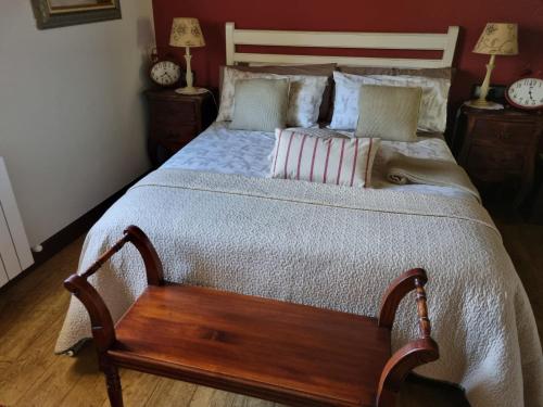 a bedroom with a large bed with a wooden frame at Gaztañeta Baserria in Olaeta