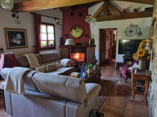 a living room with a couch and a fireplace at Gaztañeta Baserria in Olaeta