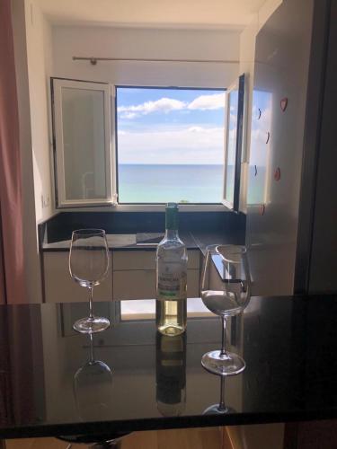 a bottle of wine on a table with two glasses at Luxury Studio Costa del Sol in Torremolinos