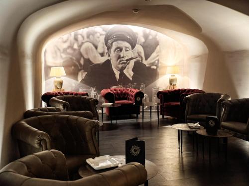 a room with a painting of a man smoking a pipe at Boutique Hotel Sonne Seuzach in Winterthur