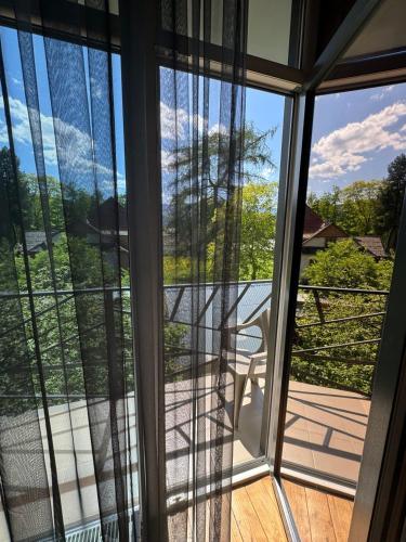 a view from a glass door of a porch at Girske Povitria 2 in Yaremche