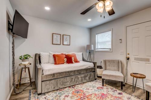 a bedroom with a bed and a tv and a chair at Charming Getaway in Stillwater in Stillwater