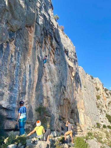 a group of people climbing on a rock mountain at Krka Ivan in Lozovac