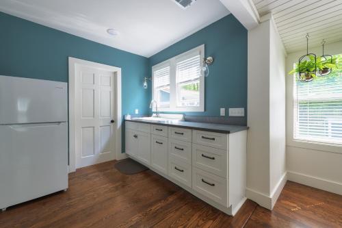 a bathroom with a sink and a blue wall at Lucky Penny - Lake Access right around the corner - Newly remodeled home in Glenn