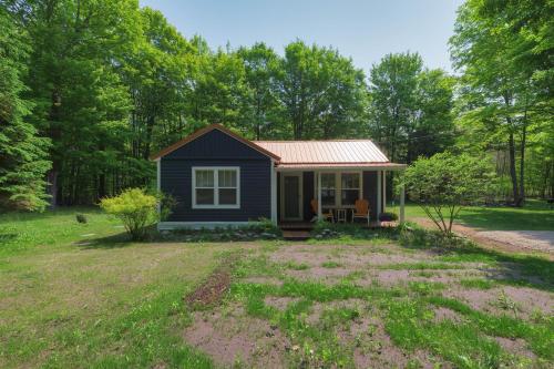 a small blue tiny house in a yard at Lucky Penny - Lake Access right around the corner - Newly remodeled home in Glenn