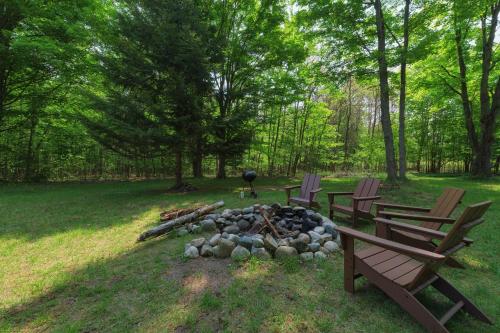 a fire pit in a park with two chairs and a grill at Lucky Penny - Lake Access right around the corner - Newly remodeled home in Glenn